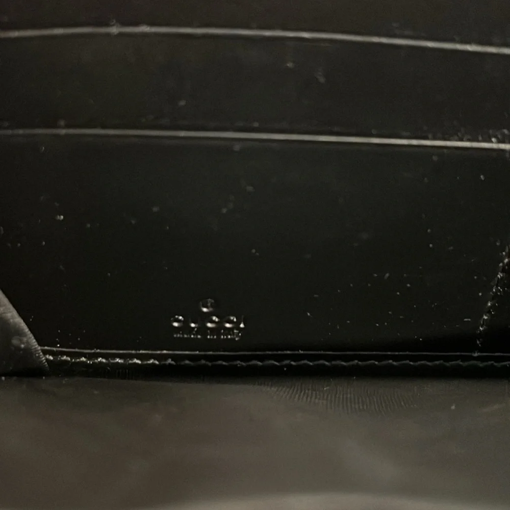Gucci Black Embossed GG Leather Zip Wallet with Gold Tone Accent